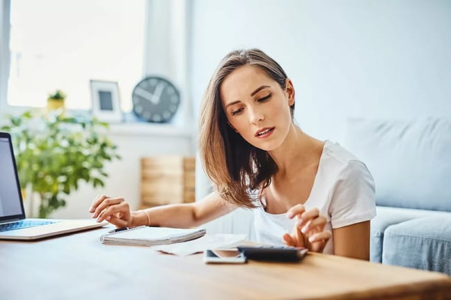 woman with calculator at home.width .jpg