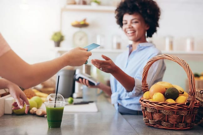 Cashier at cafe running credit card iqMfc.width .jpg