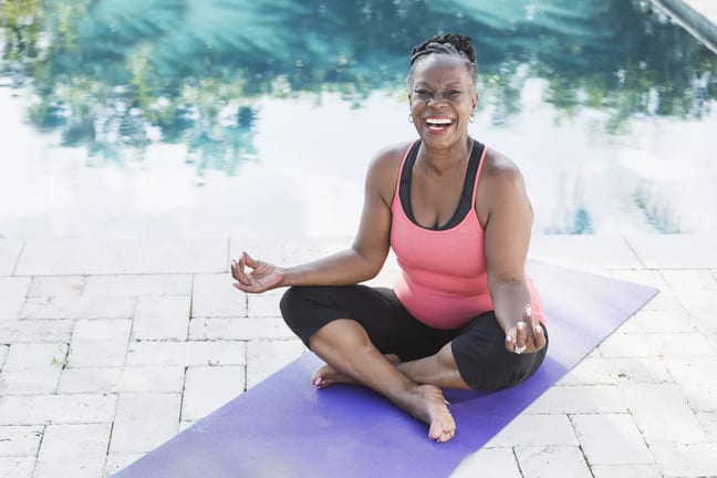 getty smiling happy meditating yoga.jpg