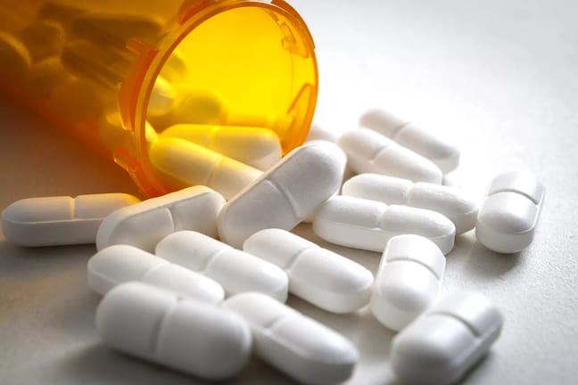 open pill bottle spilling out.jpg