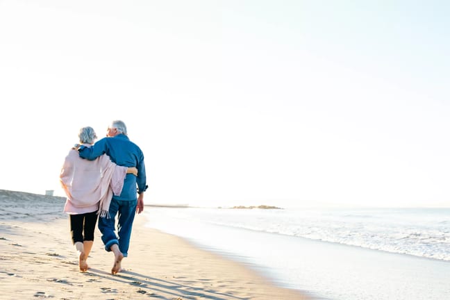 two older people walking on the beach.jpg