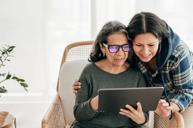 two people looking at a tablet and smiling.jpg