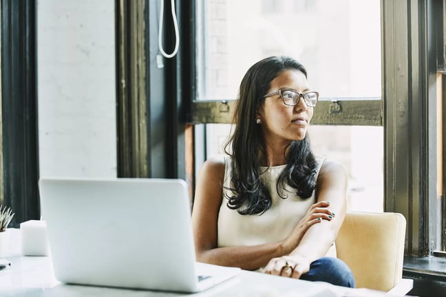 young worker looking out window and thinking.jpg