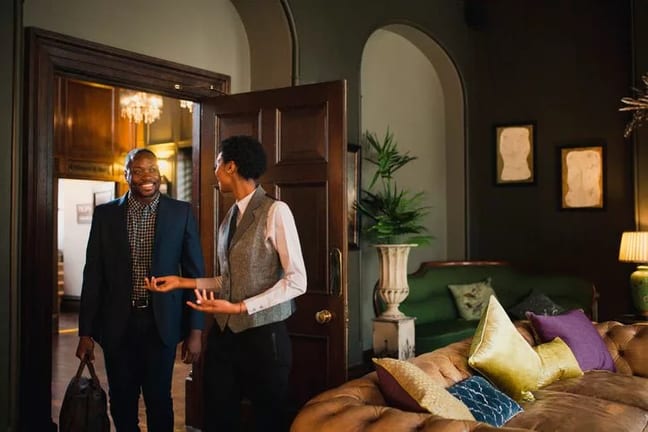 hotel employee showing guest into room miEihM.width .jpg