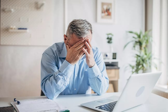 senior man laptop covering face gettyimages .jpg