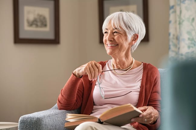 senior woman smiling book gettyimages .jpg