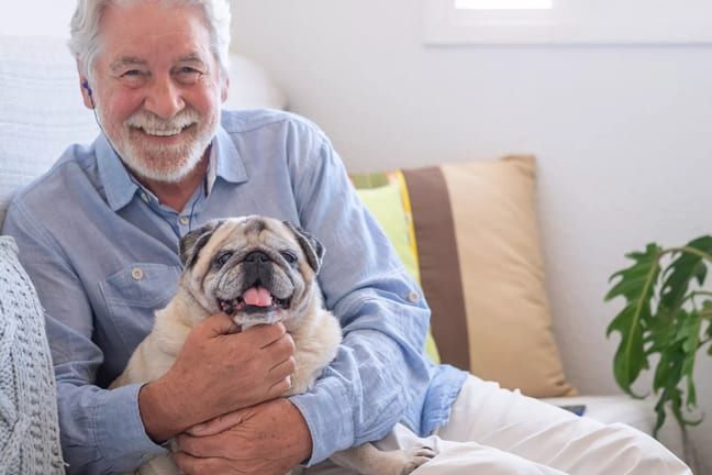 smiling person holding dog gettyimages .jpg