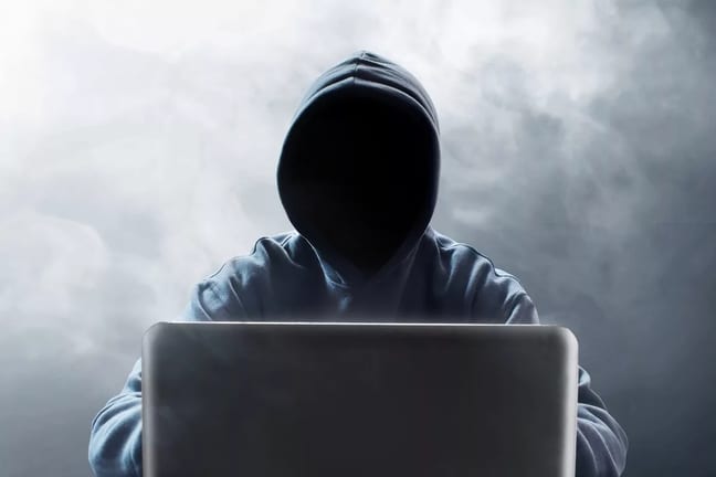 Hooded figure at laptop EBPOVYO.width .jpg