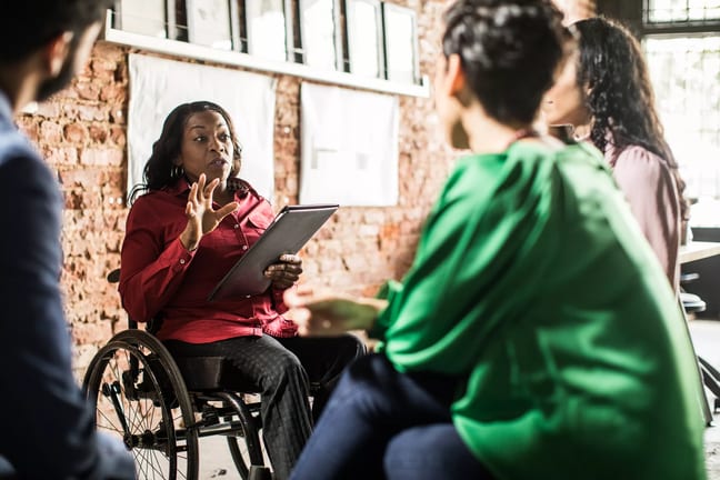 businessperson in wheelchair leading team meeting.jpg