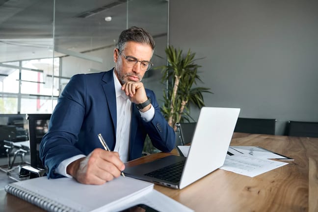 man s biz suit desk taking notes gettyimages .jpg