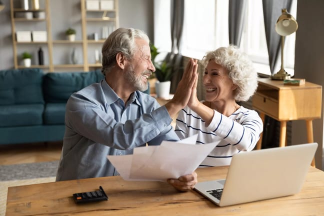 retired couple reviewing finances on a laptop.jpg
