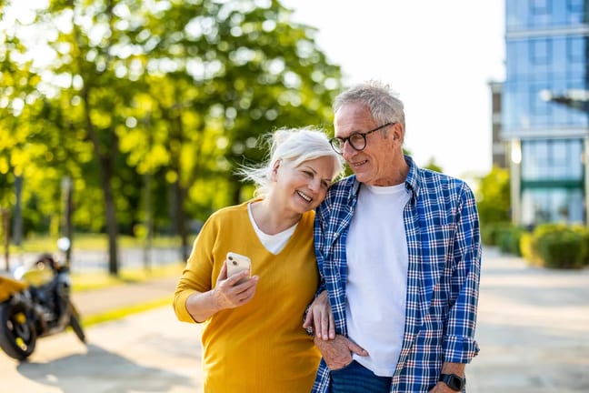 smiling couple walking down street together.jpg