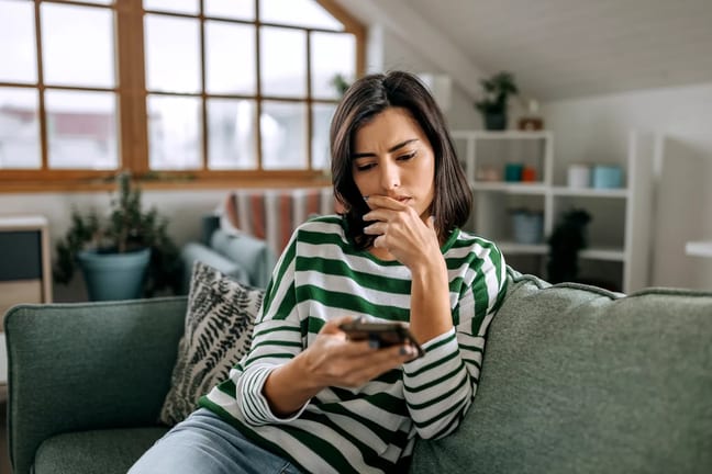 worried person looking at phone.jpg