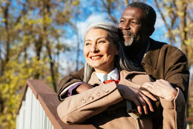retired interracial couple hugging in love x aae.jpg