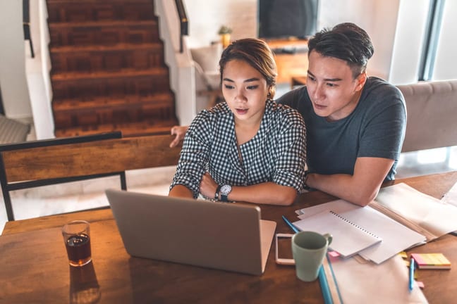 serious couple looking at laptop and discussing finances.jpg