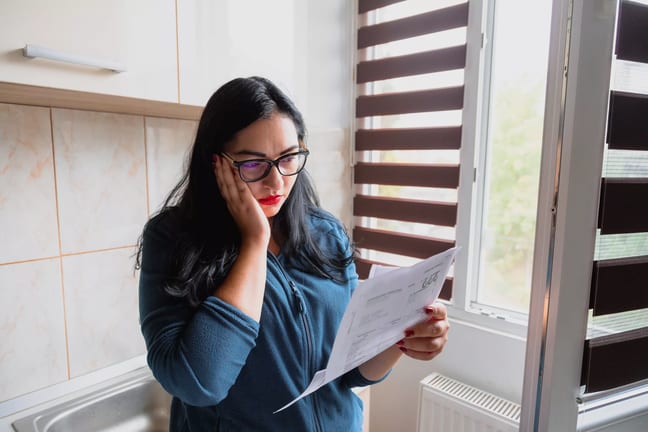 stressed businesswoman reviewing papers.jpg
