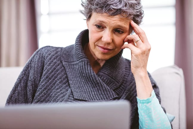 mature woman looking at laptop computer with raised eyebrows and thinking confused doubtful uncertain unsure skeptical.jpg