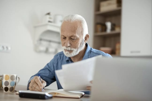 older man at desk serious gettyimages .jpg