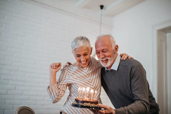 senior couple birthday cake gettyimages .jpg