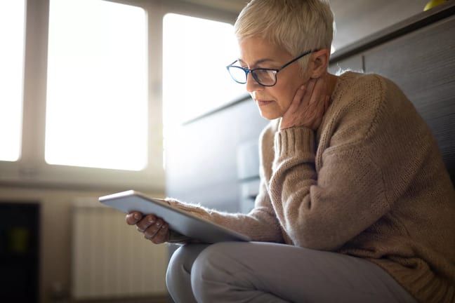 senior woman holding tablet gettyimages .jpg