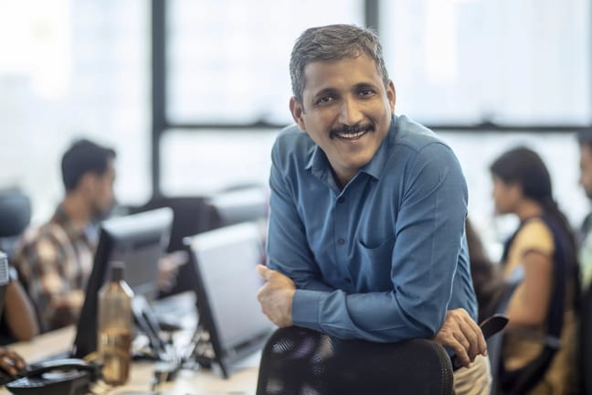 getty happy smiling business person at office.jpg