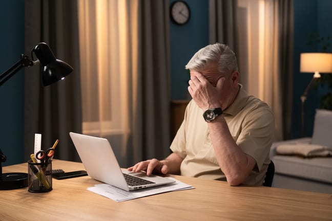 older man laptop covering face gettyimages .jpg