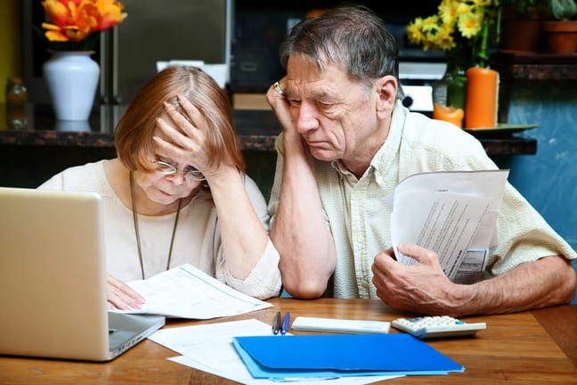 senior couple worried looking at bills finances debt.jpg