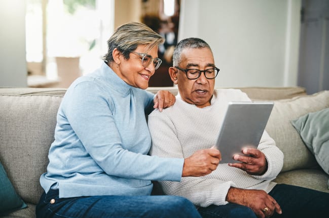 senior couple using a digital tablet at home QWPBm