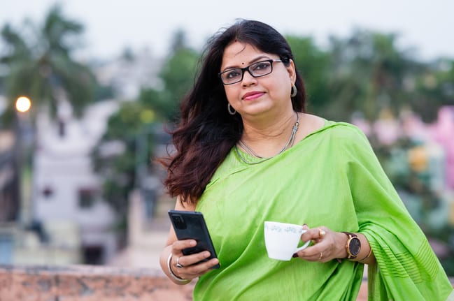 drinking tea and using her smartphone.jpg