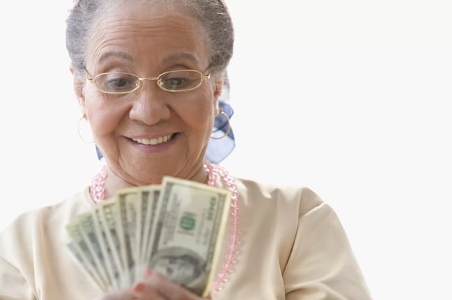 getty happy person with fanned out cash money.jpg