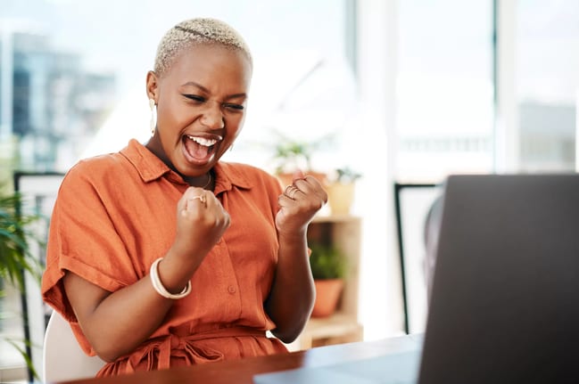 person celebrating victory while looking at computer.jpg