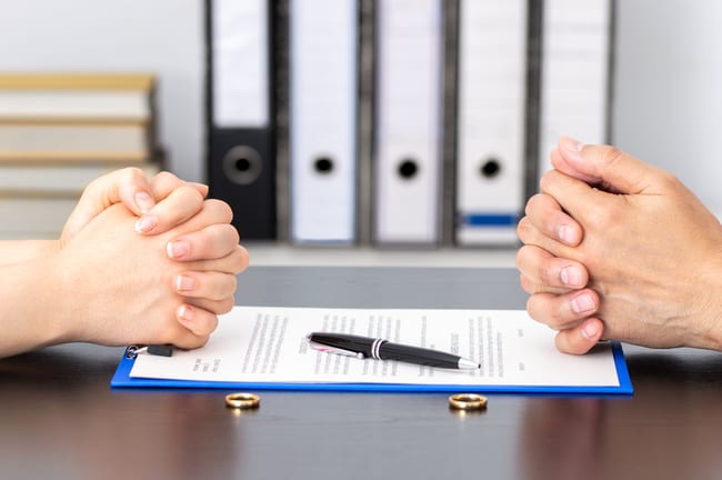 wife and husband signing for divorce.jpg