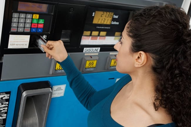Woman using a credit card to pay at the gas p.width ihWlo.jpg