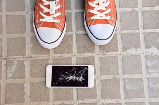 Broken cell phone on ground.width .jpg
