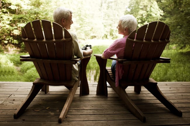senior couple sitting in chairs on porch.jpg