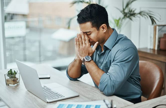 young man stressed laptop a person at a laptop putting their hands on their face and closing their eyes gettyimages .jpg