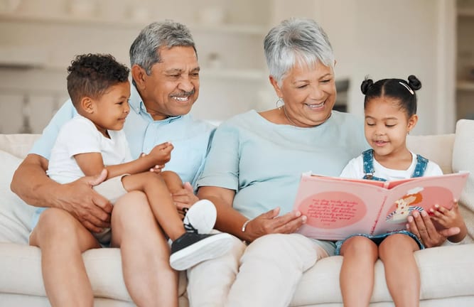 smiling couple reading books to children.jpg