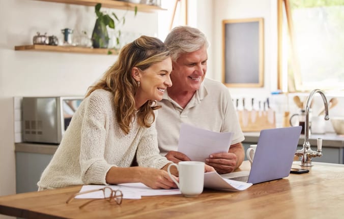 older couple smiling laptop gettyimages .jpg