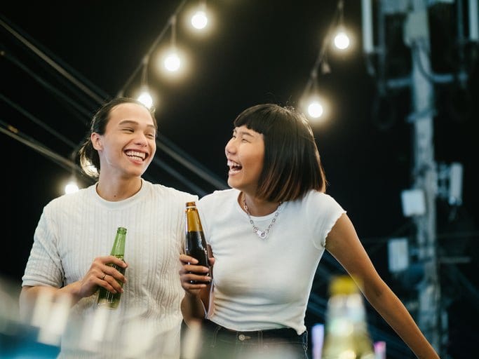 man and woman drinking beer on rooftop FlmiMS.width .jpg