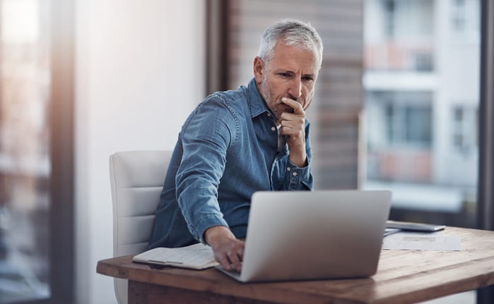 older man denim shirt laptop gettyimages .jpg
