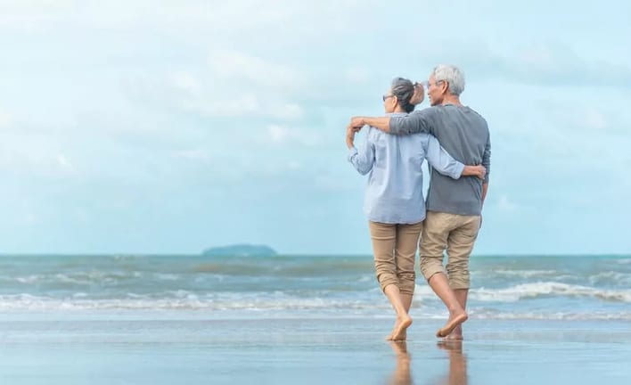 older couple walking beach.width .jpg