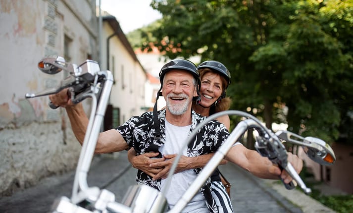 getty smiling happy couple on motorcycle.jpg