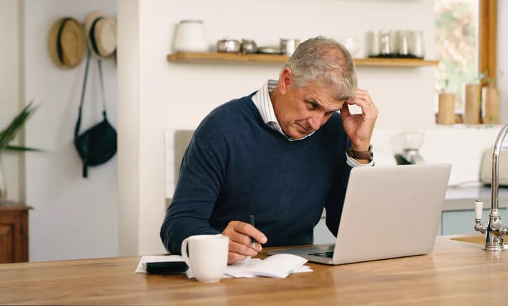 worried person looking at laptop.jpg
