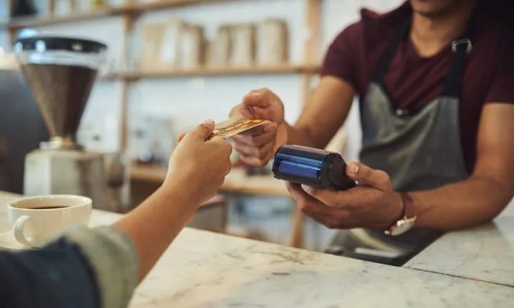 handing credit card to cafe cashier GWlfsUA.width .jpg