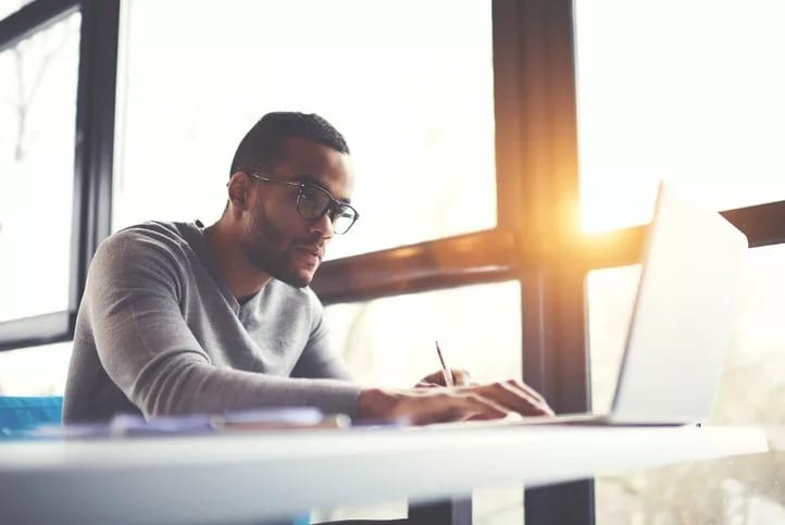 man on laptop near window.width .jpg