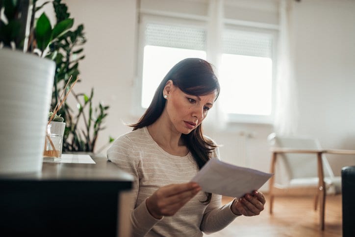 worried woman reading letter.width .jpg