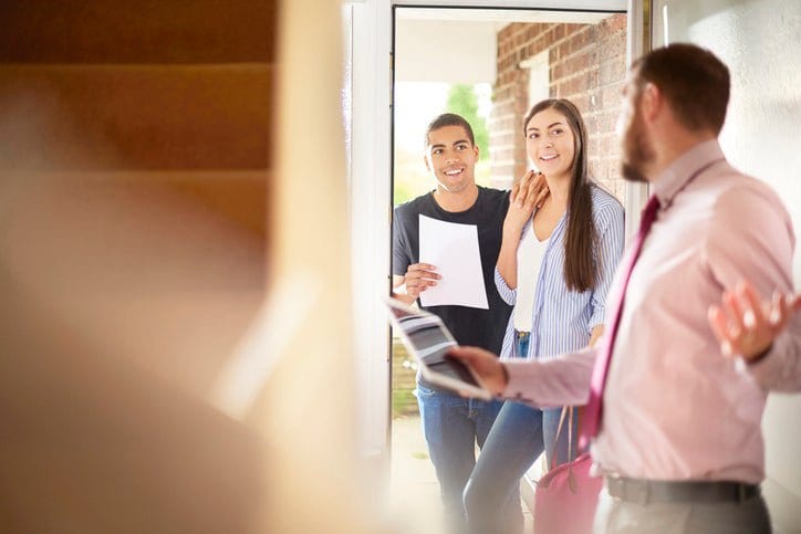 couple with realtor entering house cYeeLe.width .jpg