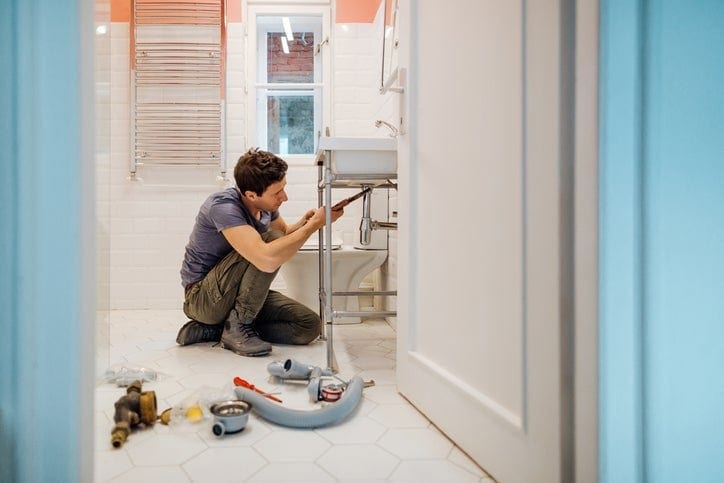 man repairing sink FHYp.width .jpg