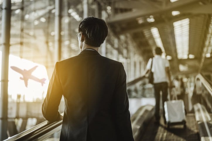 man with suitcase in airport XNAsLY.width .jpg