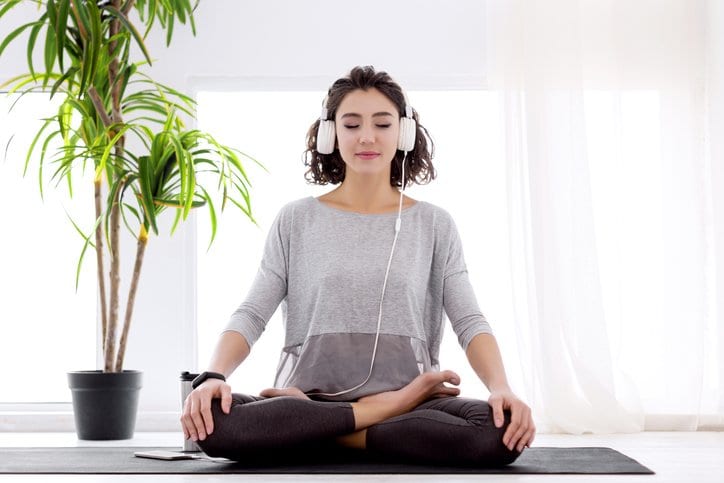 woman doing yoga with headphones.width .jpg